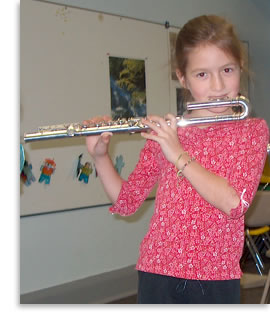 Juliana playing on her curved head flute